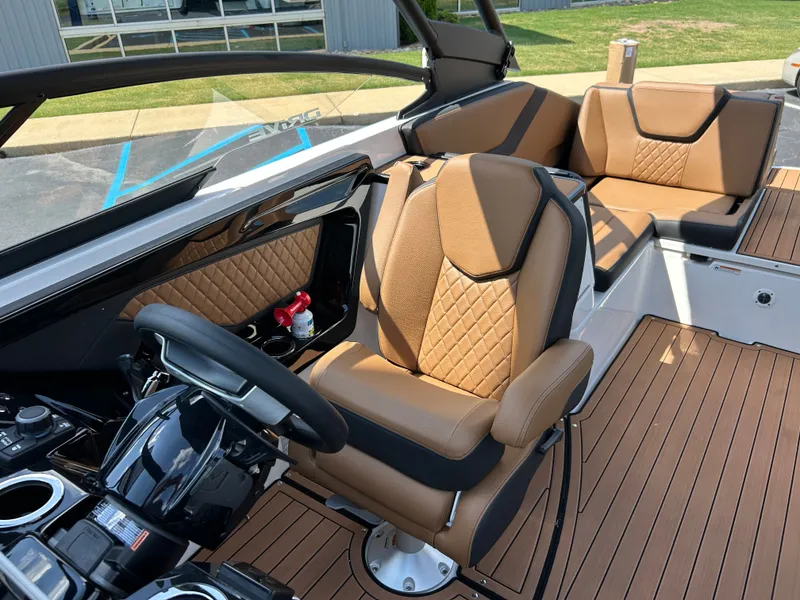 Slide: The Image of The image shows the interior of a Yamaha 252SD boat with sleek brown leather seats and a modern helm. - 14