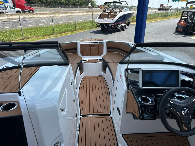 Slide: The Image of The image shows the cockpit of a Yamaha 252SD boat with modern controls and wood flooring. - 20