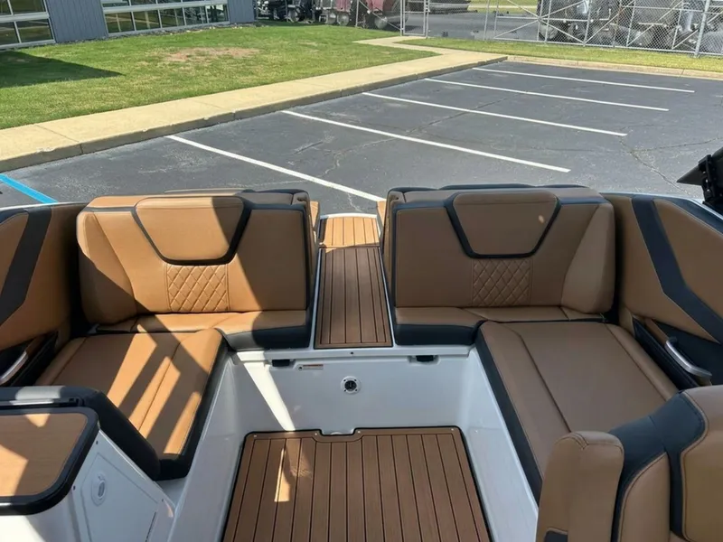 Slide: The Image of The image shows the interior of a Yamaha 252SD boat with brown seating and wood flooring. - 29