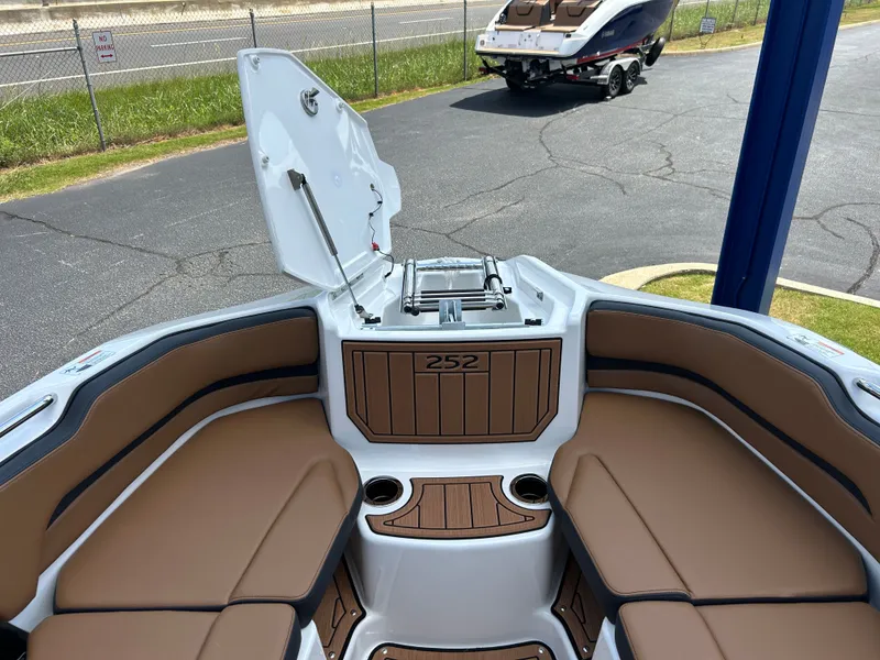 Slide: The Image of The image shows the bow of a Yamaha 252SD boat with brown upholstery and cup holders. - 24