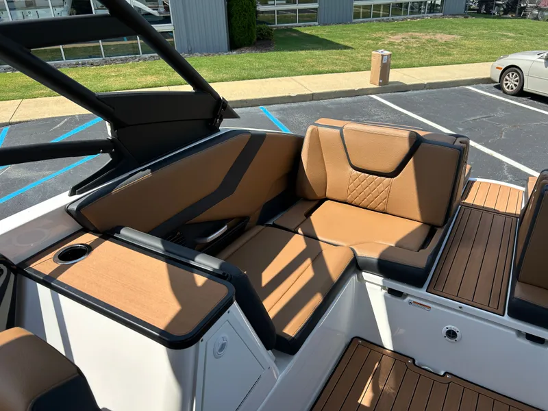 Slide: The Image of The 2026 Yamaha 252SD features a stylish seating area with brown upholstery and modern accents. - 10