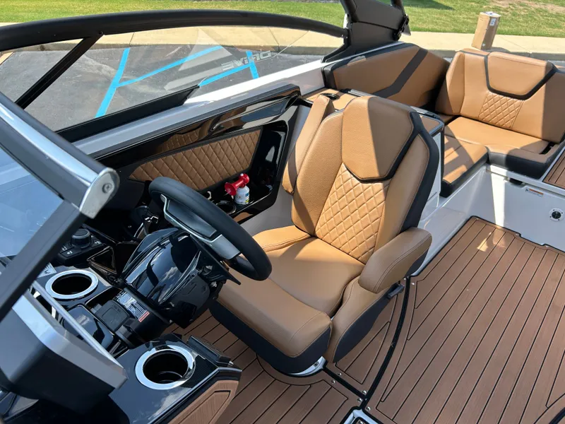 Slide: The Image of The image shows the cockpit of a 2026 Yamaha 252SD boat with sleek brown leather seats. - 13
