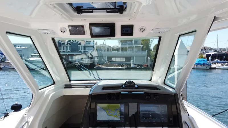 Slide: The Image of Interior view of a Tiara Sport 34LS boat with modern electronics and a harbor view. - 10