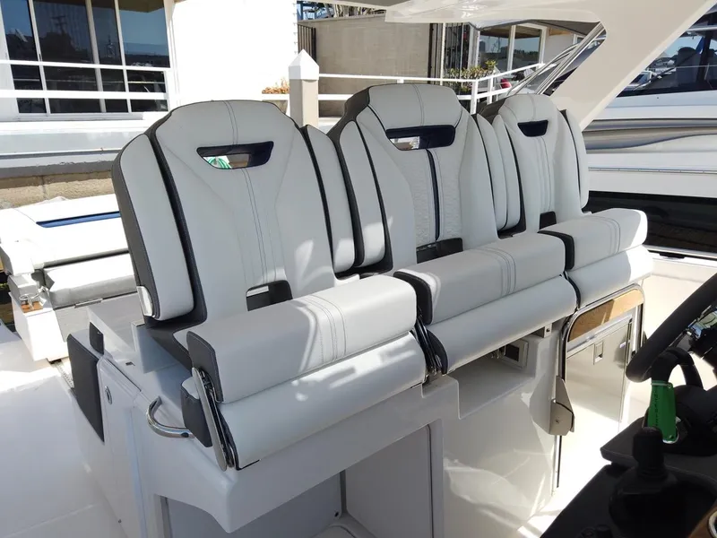 Slide: The Image of Three luxurious, cushioned seats on a modern boat, surrounded by sleek white surfaces. - 11