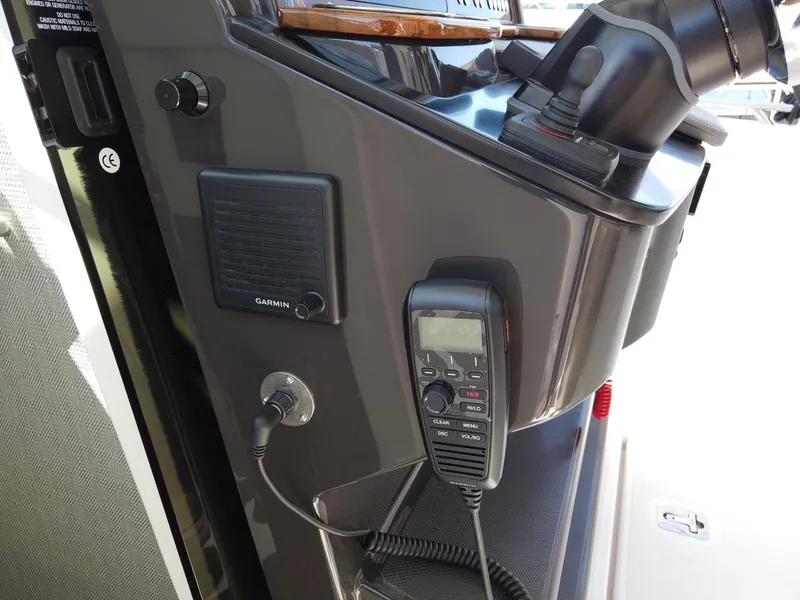 Slide: The Image of Close-up of a boat console area with Garmin device and radio. - 15