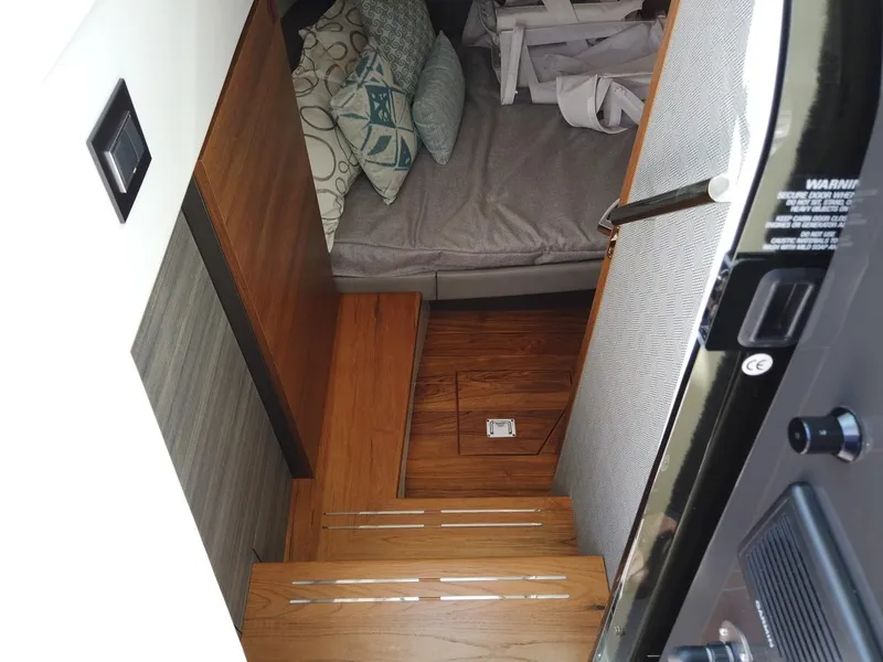 Slide: The Image of Tiara Sport 34LS 2024: Interior view with wooden stairs and cozy seating area. - 16