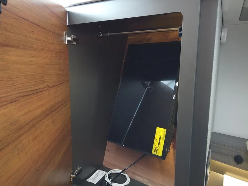 Slide: The Image of Interior view of a cabinet with a screen in the 2024 Tiara Sport 34LS. - 19
