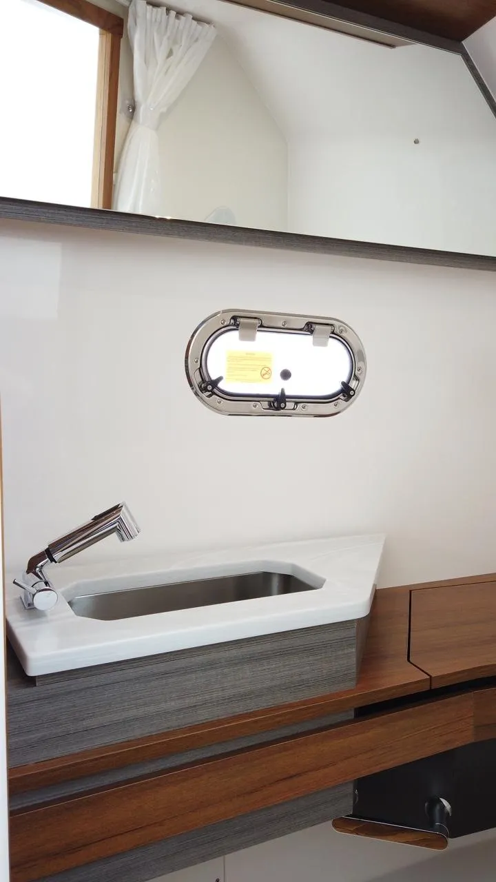 Slide: The Image of Interior view of a 2024 Tiara Sport 34LS with a sink and window. - 21
