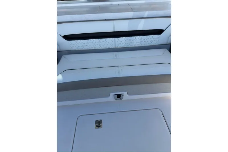 Slide: The Image of 2024 Tiara Sport 34LS boat interior seating with sleek, modern design and storage compartment. - 29