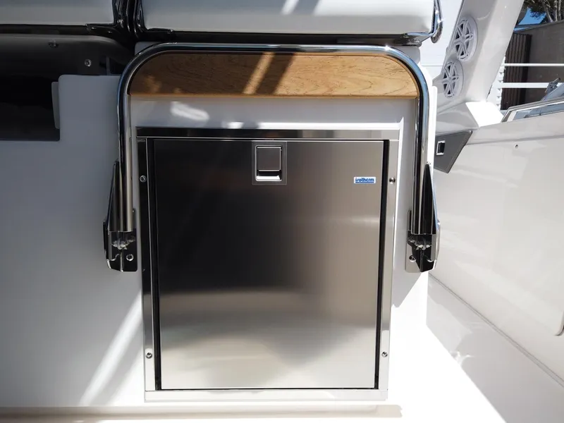Slide: The Image of Stainless steel refrigerator door on a boat, surrounded by white surfaces and metal railings. - 4