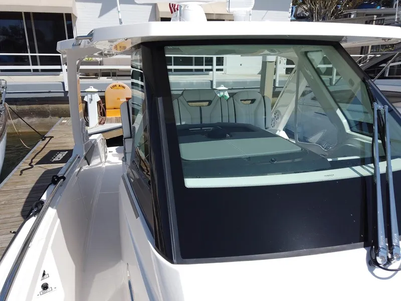 Slide: The Image of 2024 Tiara Sport 34LS at dock with sleek design and spacious cockpit. - 5