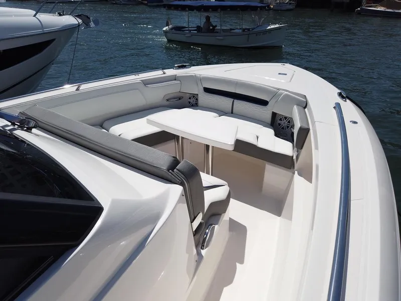 Slide: The Image of The image shows the deck of a 2024 Tiara Sport 34LS boat with seating area and table. - 6