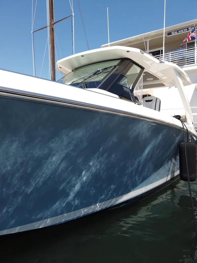 Slide: The Image of The 2024 Tiara Sport 34LS is on the water, featuring a blue hull and white deck. - 9