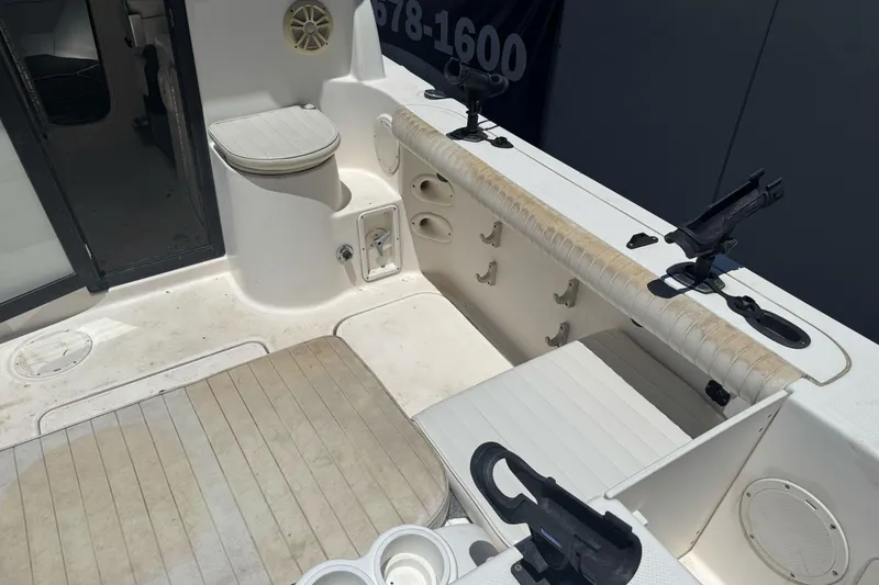 Slide: The Image of 2004 Trophy 2359 WA boat interior with seating, rod holders, and storage compartments. - 10