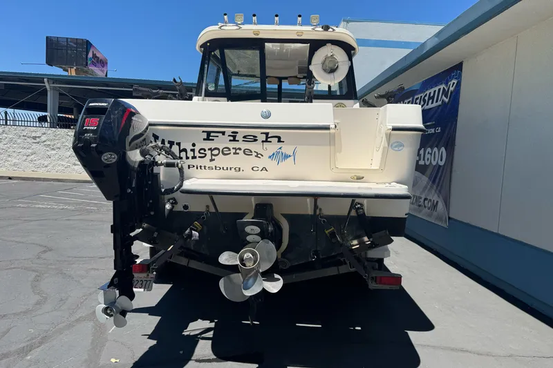 Slide: The Image of 2004 Trophy 2359 WA boat with "Fish Whisperer" text, parked outdoors in Pittsburg, CA. - 7