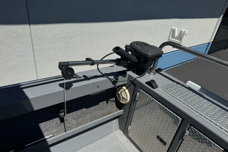 Slide: The Image of Interior of a 2014 River Hawk 19 GB boat featuring fishing equipment and storage compartments. - 11
