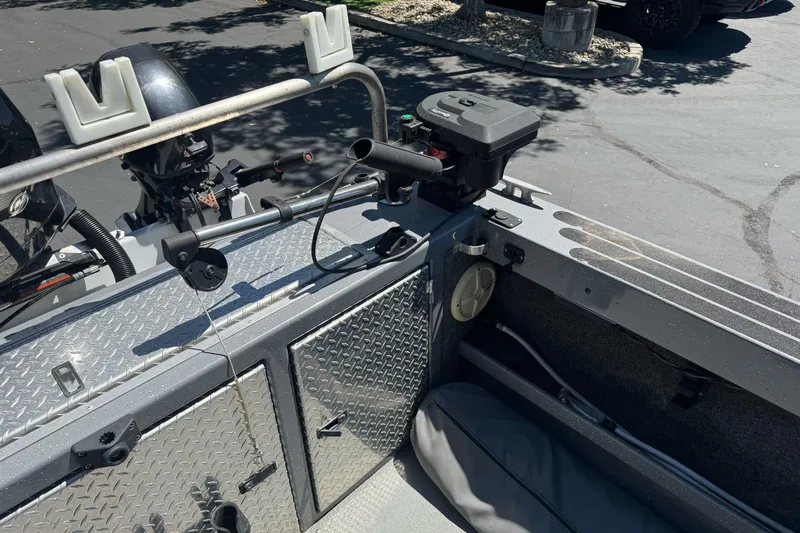 Slide: The Image of Interior of a 2014 River Hawk 19 GB boat with motor and storage compartments. - 12