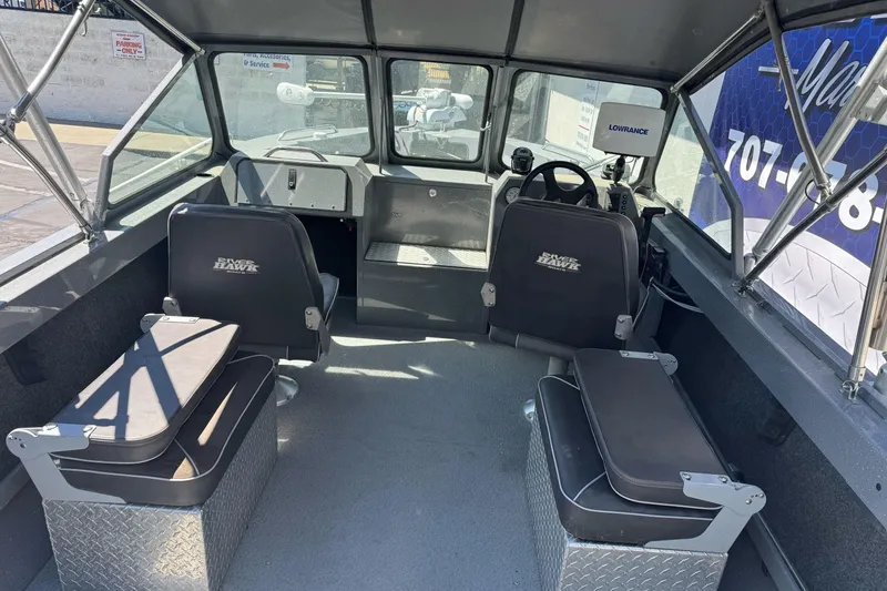 Slide: The Image of Interior of a 2014 River Hawk 19 GB boat with seating and navigation equipment. - 14