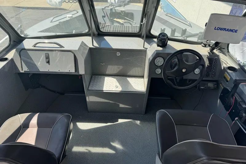 Slide: The Image of Interior of a 2014 River Hawk 19 GB boat with steering wheel and navigation equipment. - 18