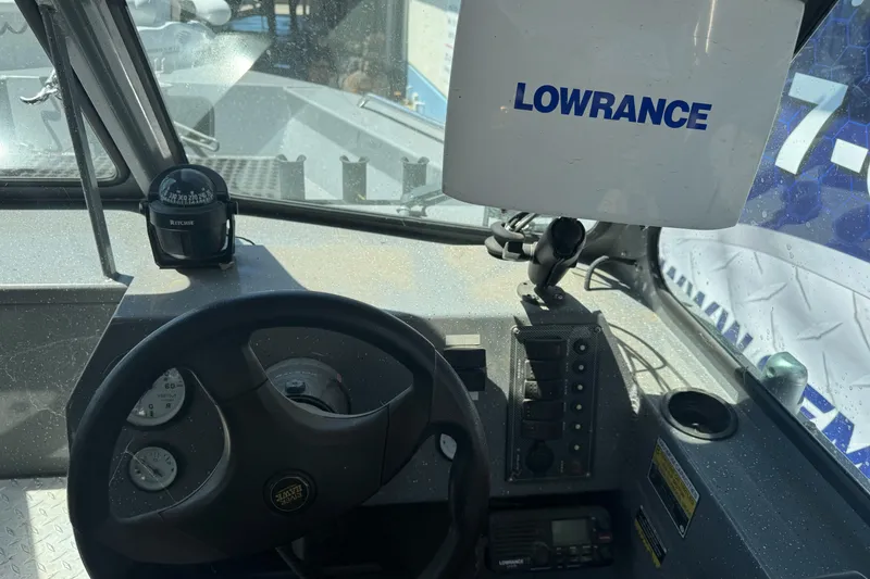 Slide: The Image of Interior of a 2014 River Hawk 19 GB boat with Lowrance navigation system. - 19