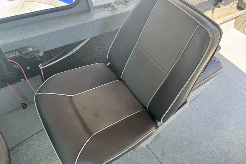 Slide: The Image of Black cushioned seat in a 2014 River Hawk 19 GB boat interior. - 20