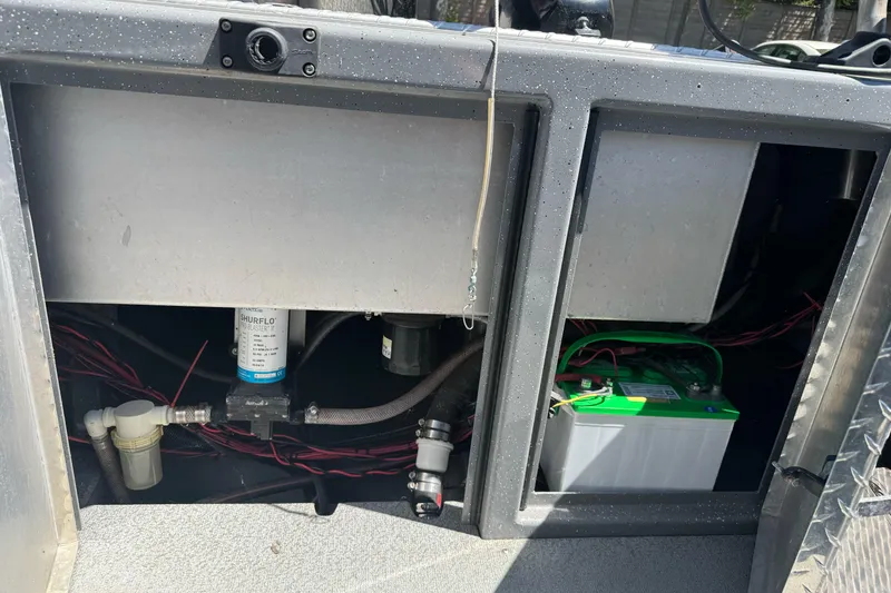 Slide: The Image of 2014 River Hawk 19 GB boat compartment with battery and wiring. - 27