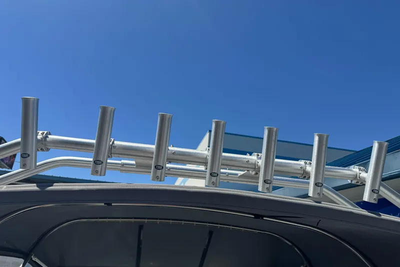 Slide: The Image of Aluminum rod holders on a 2014 River Hawk 19 GB boat under clear blue sky. - 28