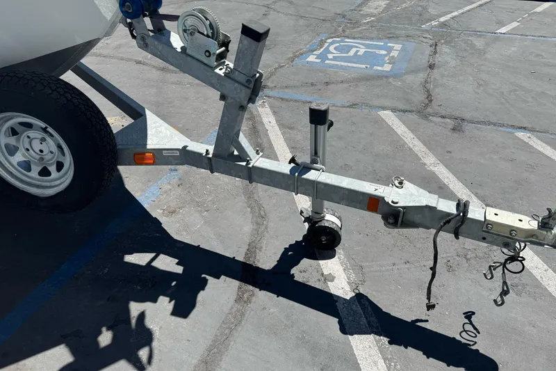 Slide: The Image of Trailer hitch of a 2014 River Hawk 19 GB boat in a parking lot. - 3