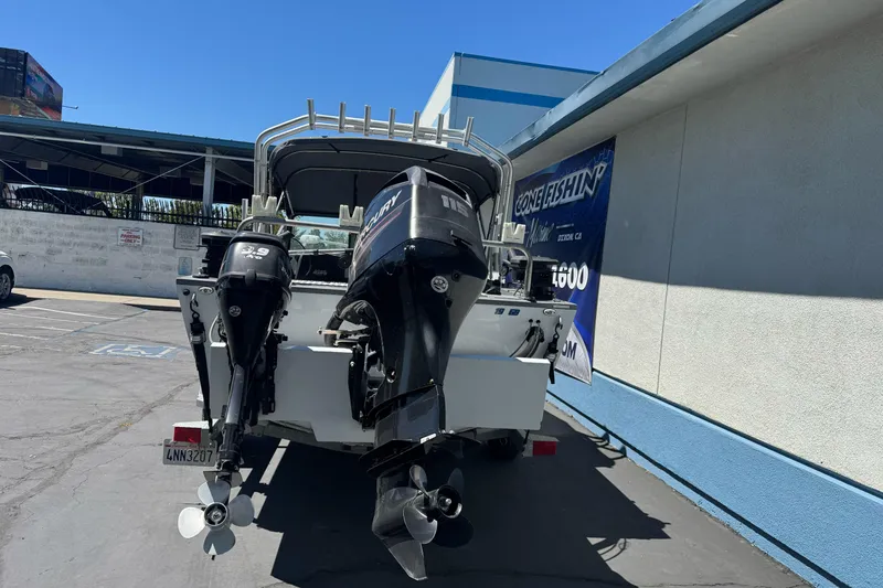 Slide: The Image of 2014 River Hawk 19 GB boat with dual Mercury outboard motors in a parking lot. - 7