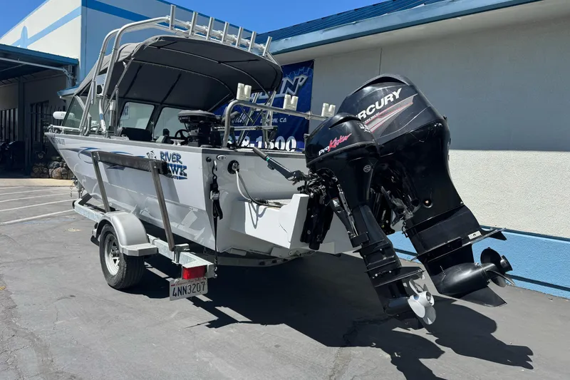 Slide: The Image of 2014 River Hawk 19 GB boat with Mercury outboard motor on a trailer. - 8