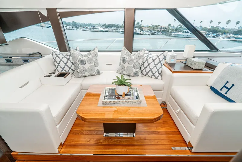 Slide: The Image of Elegant interior of a 2017 Tiara Yachts C53 Coupe with white sofas and wooden table. - 14