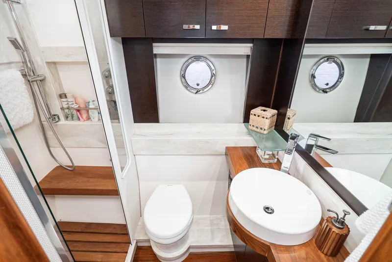 Slide: The Image of The image shows an elegant yacht bathroom with wood paneling and modern fixtures. - 24