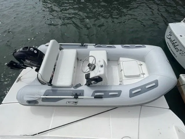 Slide: The Image of A small inflatable boat with an outboard motor is docked. - 48