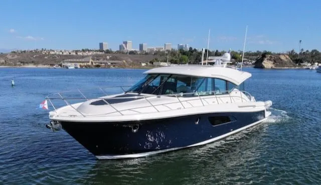 Slide: The Image of The 2017 Tiara Yachts C53 Coupe glides on calm waters, featuring a sleek design and spacious cabin. - 1