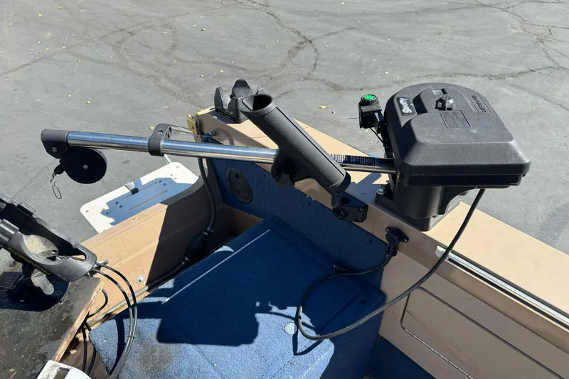 Slide: The Image of 1998 Lund 1700 Pro Sport boat interior with trolling motor and rod holder. - 13