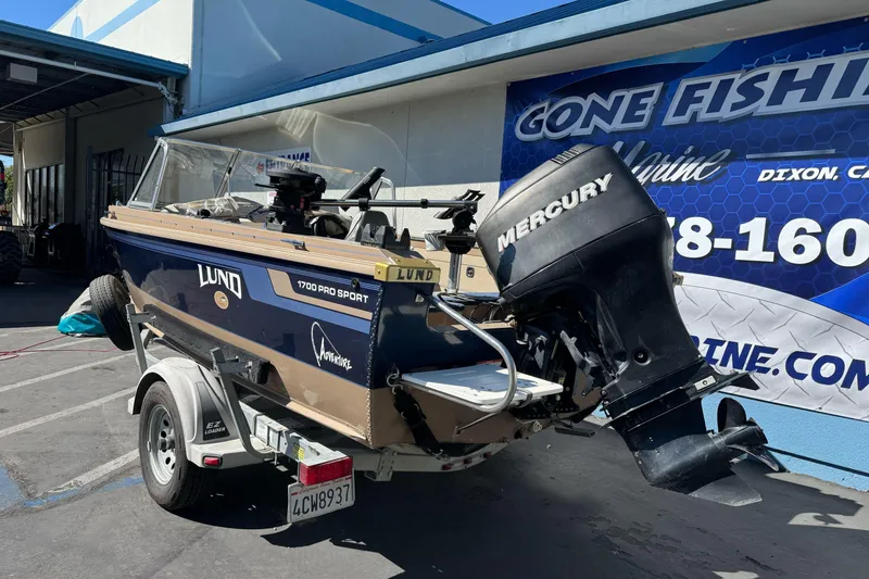 Slide: The Image of 1998 Lund 1700 Pro Sport boat with Mercury outboard motor on trailer. - 5