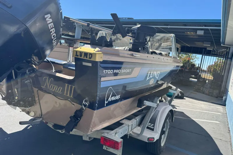 Slide: The Image of 1998 Lund 1700 Pro Sport boat on trailer, featuring Mercury outboard motor. - 7