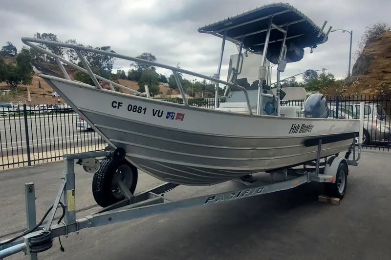 Slide: The Image of 2017 Klamath Bayrunner 19 Baja boat on trailer, parked outdoors. - 1