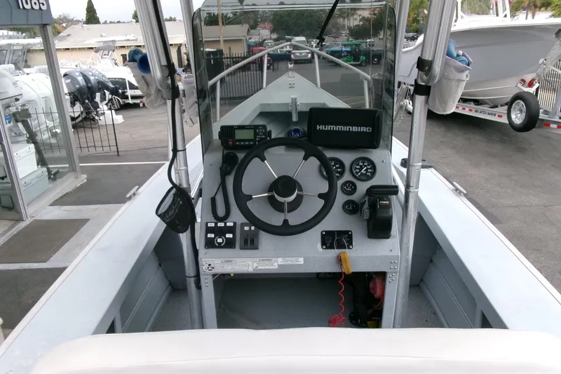 Slide: The Image of 2017 Klamath Bayrunner 19 Baja boat dashboard with steering wheel and navigation equipment. - 8