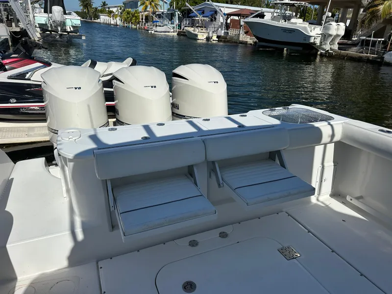 Slide: The Image of 2008 Everglades 350 CC boat with triple V8 engines docked at a marina. - 10