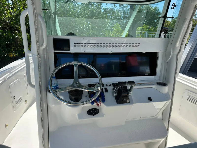 Slide: The Image of 2008 Everglades 350 CC boat helm with steering wheel and control panel. - 12
