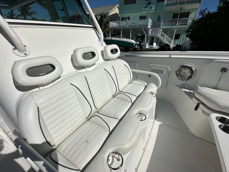 Slide: The Image of 2008 Everglades 350 CC boat interior with white seating and cup holders. - 14