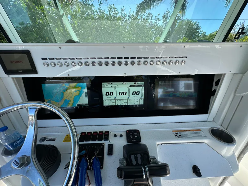 Slide: The Image of 2008 Everglades 350 CC boat dashboard with navigation screens and controls. - 18