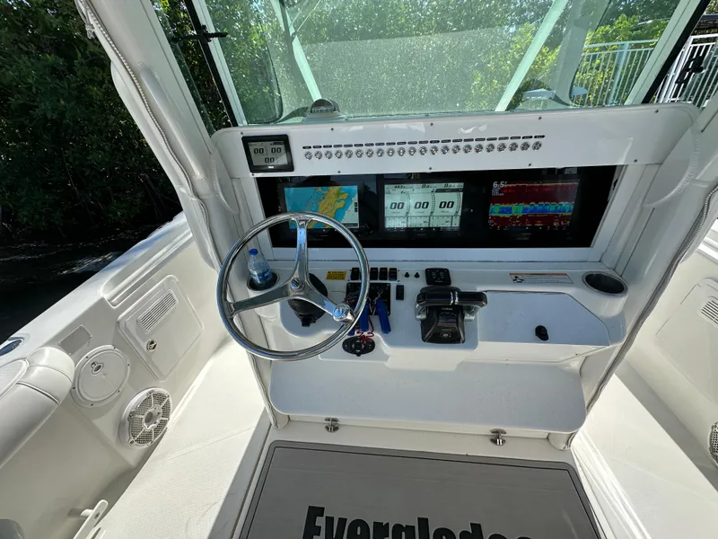 Slide: The Image of 2008 Everglades 350 CC boat dashboard with steering wheel and navigation screens. - 21