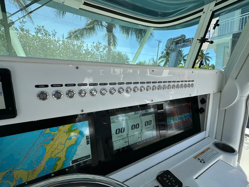 Slide: The Image of Dashboard of a 2008 Everglades 350 CC boat with navigation screens and controls. - 27