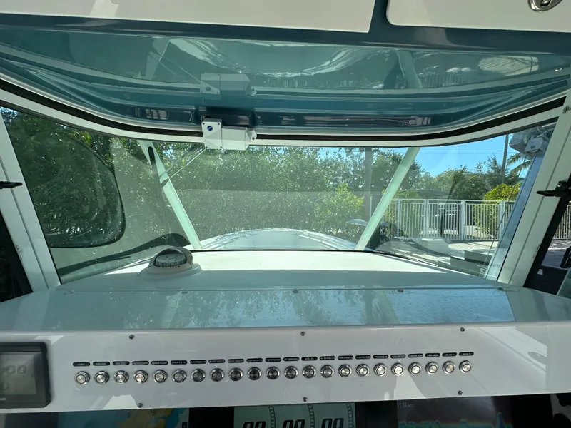 Slide: The Image of 2008 Everglades 350 CC boat dashboard with control panel and windshield view. - 28