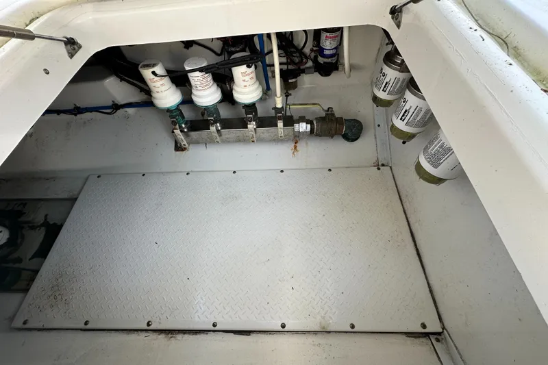 Slide: The Image of 2008 Everglades 350 CC boat compartment with filters and wiring. - 30