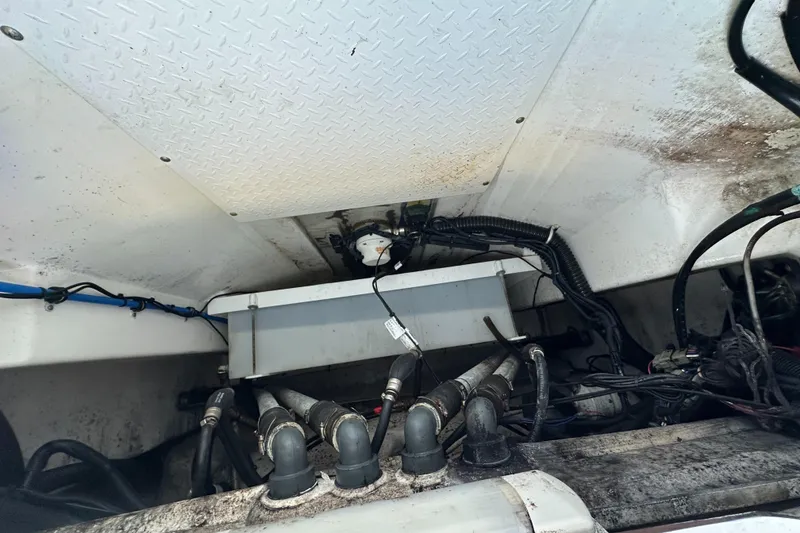 Slide: The Image of Engine compartment of a 2008 Everglades 350 CC boat, showing wiring and hoses. - 31