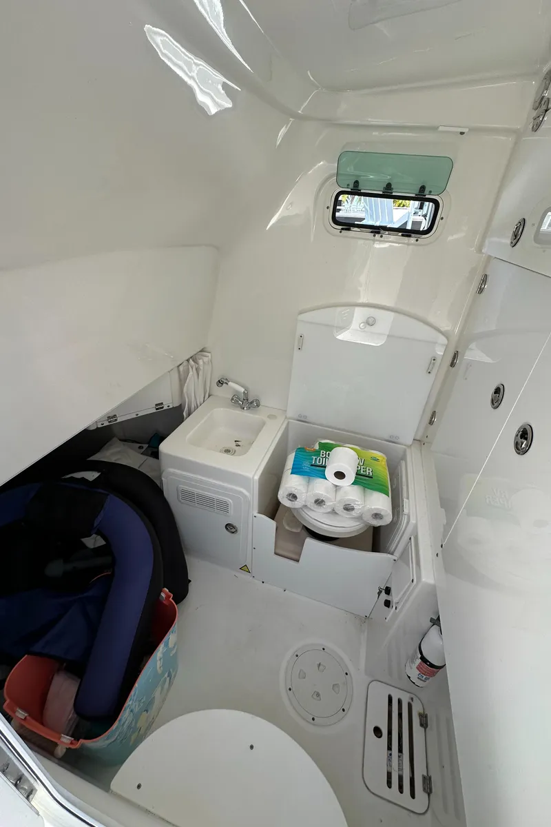 Slide: The Image of 2008 Everglades 350 CC boat interior with compact bathroom and storage. - 33