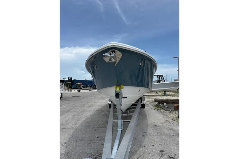 Slide: The Image of 2009 Everglades 350 Center Console boat on trailer, parked outdoors under clear sky. - 4
